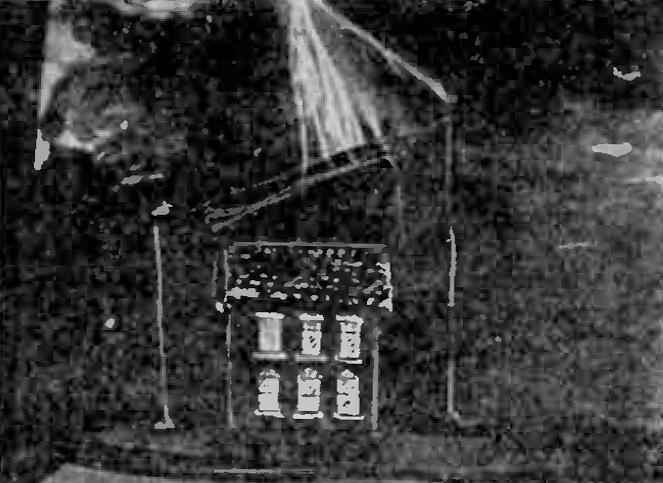 Model house with aerial protection exposed to Tesla coil discharges