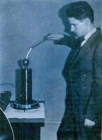 Kenneth Swezey accepting arcs from his Tesla coil