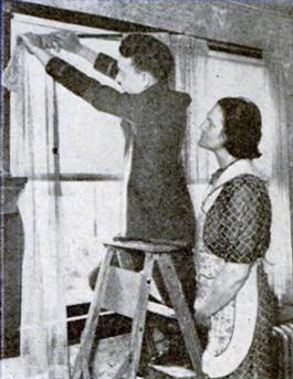 Telegraph boy hanging draperies