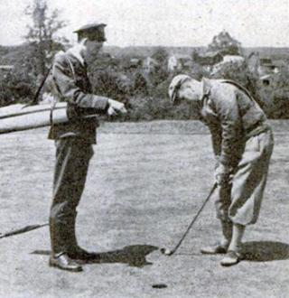Telegraph boy providing caddy services for golfer