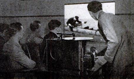 Telegraph boy operating a projector