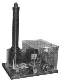 Miniature Tesla coil protected by clear plastic enclosure.