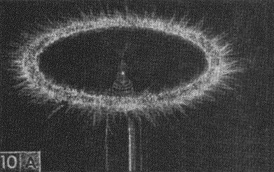 Miniature Tesla coil pinwheel spinner in operation.