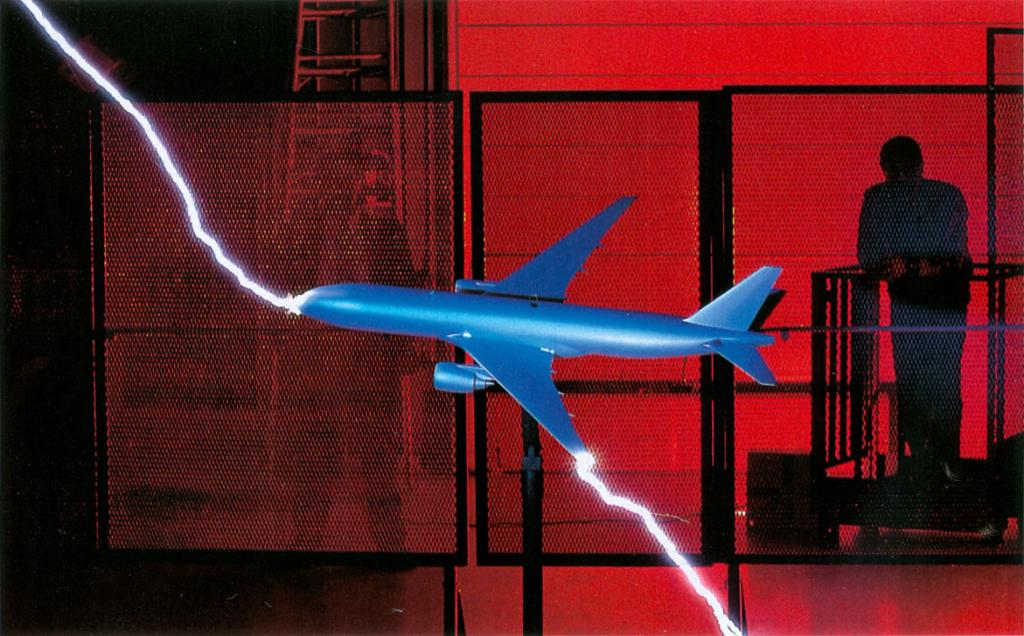 Scale model airplane passing artificial lightning discharge