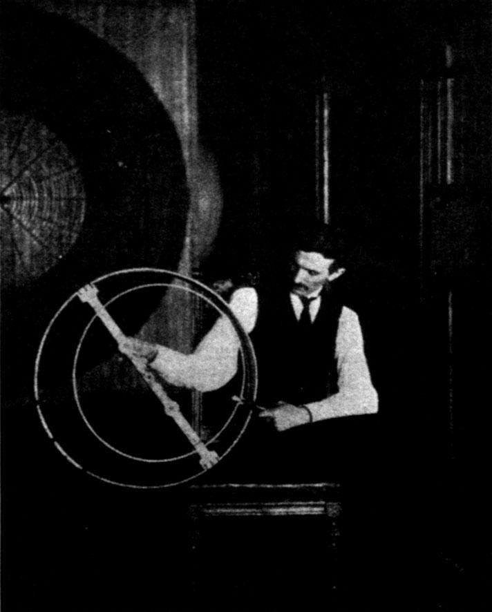 Figure 4 - Tesla working on a resonator coil in his Houston St. lab, 1899.
