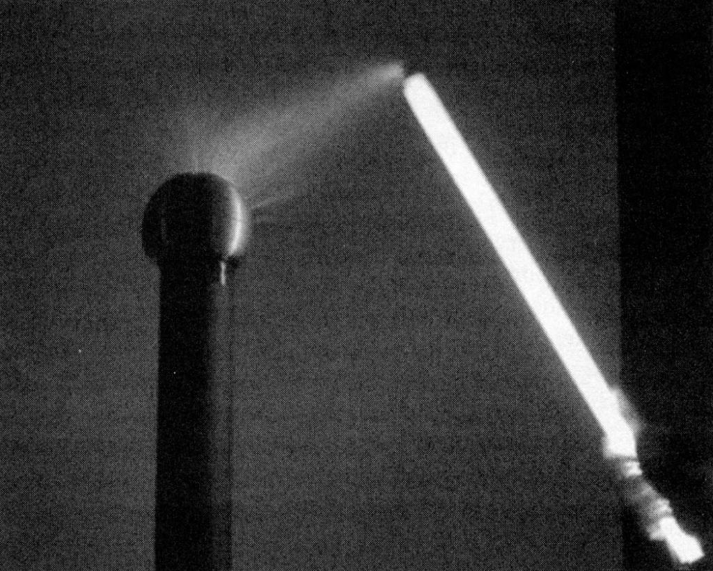 Tesla’s wireless fluorescent light lit by a Tesla coil.