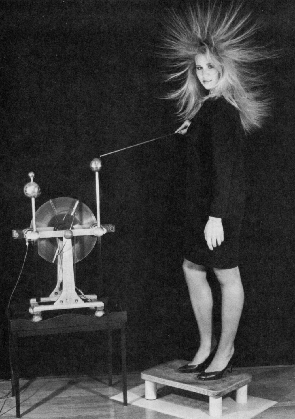 Girl with electrostatic charged hair from Wimshurst machine.
