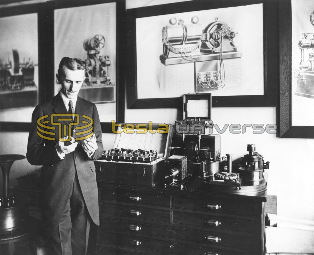 Nikola Tesla in his office in 1916, demonstrating an electrical apparatus