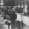 Workers pose near a Westinghouse-Tesla generator in the Edward Dean Adams power station