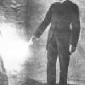 Nikola Tesla lighting a disconnected vacuum bulb.