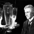 Nikola Tesla in his laboratory with late type mercury arc rectifier tubes