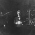 Mark Twain participating with experiment as Tesla watches from behind