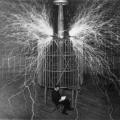 Nikola Tesla seated inside his Colorado Springs oscillator while giant sparks leap around him